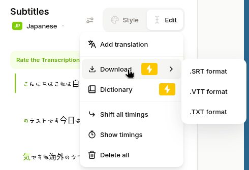 VEED の字幕のメニュー(2026年10月20日)。Add translation、Download(稲妻の印)、Dictionary(稲妻の印)、Shift all timings、Show timings、Delete all。Download の横に .SRT format、.VTT format、.TXT format